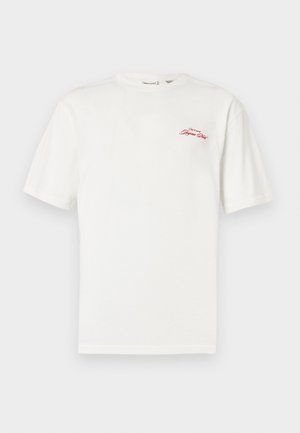 White cotton t-shirt with short sleeves and a round neckline. Features a red embroidered logo on the left chest area.