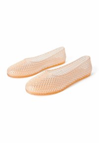 Transparent plastic ballet flats with a diamond lattice pattern, in a light peach color, featuring a rounded toe and flat sole.