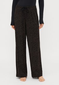 Pantaloni neri con motivo a leopardo; realizzati in materiale morbido; presentano una vita elastica con lacci e un design a vestibilità rilassata.