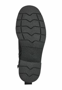 Suola nera in gomma texturizzata, con un motivo a zigzag per una migliore aderenza. Include una cerniera laterale e una sezione del tacco arrotondata.