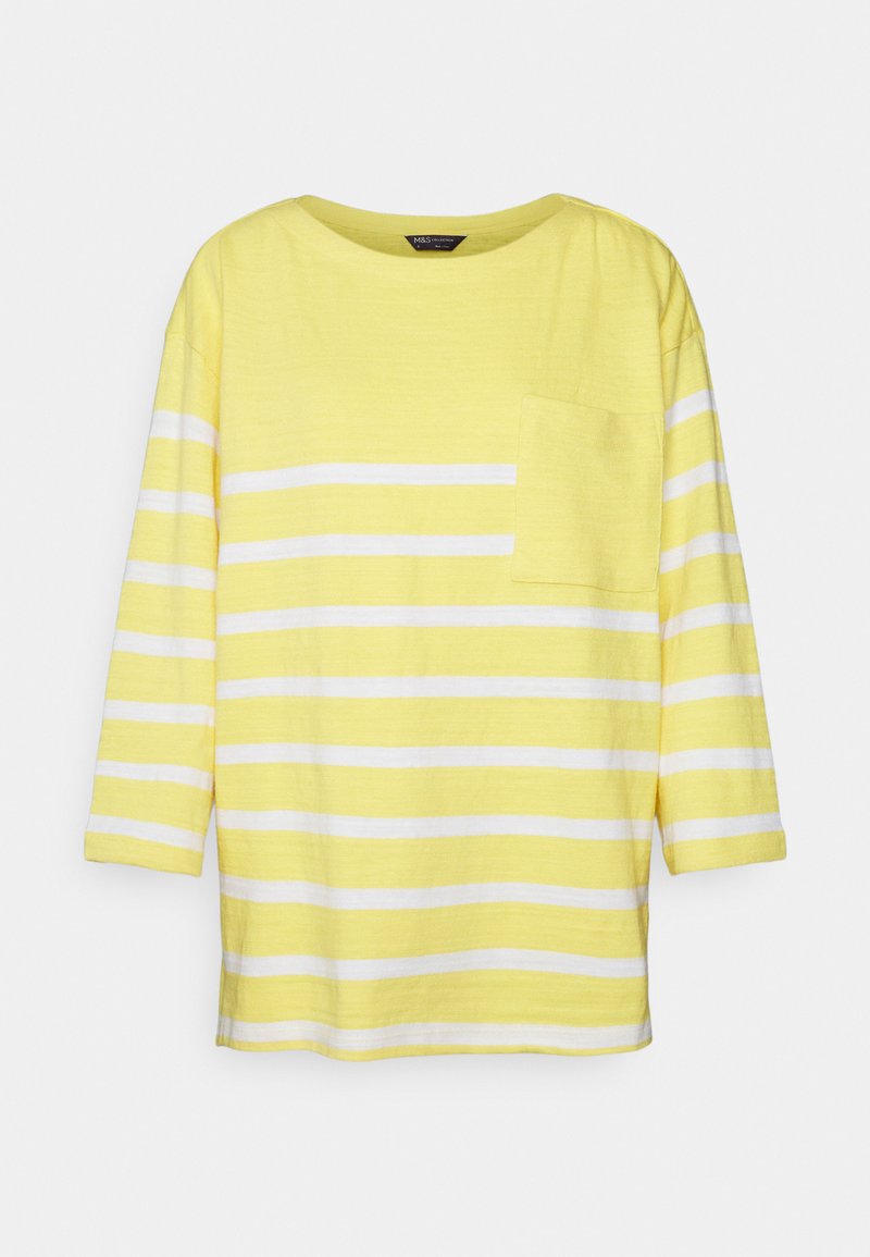 T-shirt listrada em amarelo e branco com decote redondo, mangas três quartos e um bolso no lado esquerdo do peito. Tecido macio e leve.