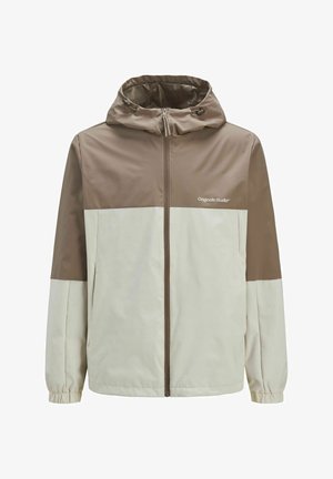Giacca color block marrone e crema con cappuccio, chiusura con zip, polsini elasticizzati e logo "Originals Studio" sul petto. Tessuto liscio.