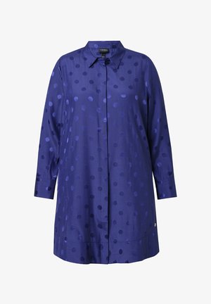 Pitkähiha, kauluksellinen paita, joka on valmistettu sileästä tummansinisestä kankaasta, jossa on erikokoisia, kiiltäviä laivastonsinisiä pisaroita; siinä on napitus.