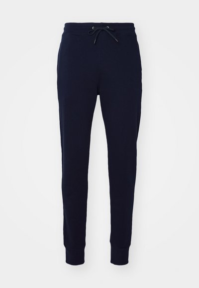 Ναυτικές jogger παντέλόνες κατασκευασμένες από μαλακή μείγμα βαμβακιού, με ελαστική μέση και κορδόνι, καθώς και ριμπ μανσέτες στους αστραγάλους.