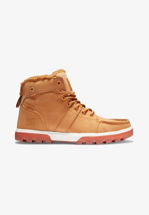 Tan leather high-top boots with a soft, textured collar. Features laces, a white midsole, and a textured orange outsole with grip pattern.