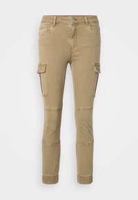 Beige cargo kalhoty s elastickými manžetami, předními a bočními kapsami a kontrastním prošíváním. Vyrobeny z odolné směsi bavlny.