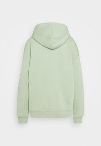 Světlé zelené mikina s kapucí vyrobená z měkkého materiálu, s volnějším střihem, dlouhými rukávy a prostornou kapucí. Minimalistický design, bez vzorů.