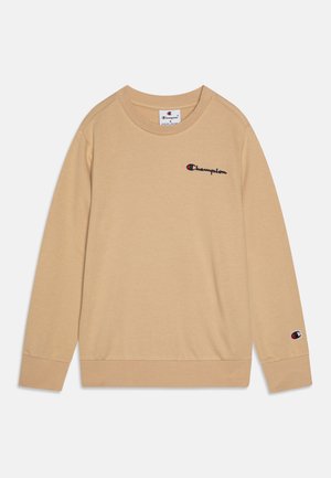 Sweatshirt beige en tissu doux, avec un col rond et des manches longues. L'avant présente un logo en broderie noire et rouge.
