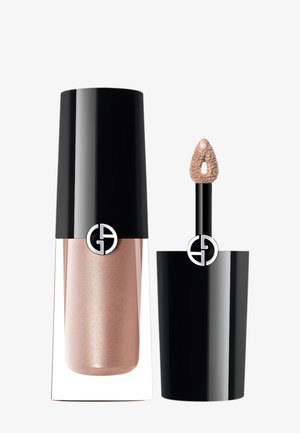 Gloss à lèvres dans un récipient transparent avec un capuchon noir. Le gloss est d'un rose doré pailleté. L'applicateur a une pointe texturée pour une application en douceur.