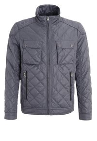 Mørkegrå quiltet jakke med høj krave, frontlynlås, to brystlommer med knapper og to sidelommer med lynlås.