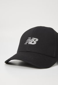 Casquette de baseball noire en coton avec une visière incurvée. Présente un logo "NB" brodé en gris à l'avant. Texture lisse, design structuré.