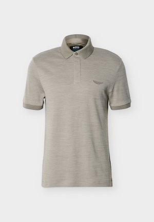 Rövid ujjú bézs poloing bordázott gallérral és mandzsettákkal, gombos patttal és kis hímzett logóval a mellkason.