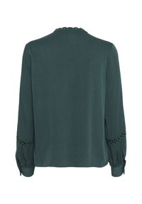 Blusa verde scuro con maniche lunghe, caratterizzata da orlo in pizzo sulle maniche e sul colletto, realizzata in un tessuto morbido con una vestibilità ampia.