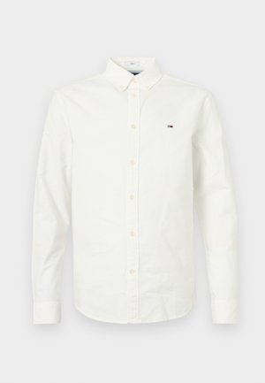 Witte lange mouwen button-up shirt van katoen. Heeft een puntige kraag, knoopsluiting en een klein logo op de linkerkant van de borst. Sukkelige textuur.