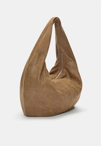Brown suede hobo bag with a slouchy design, featuring a single, wide handle and a zippered pocket on the side. Soft texture and curved shape.