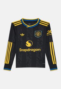 Mustard must sleeves jersey, mille ja siniste aktsentidega, õlgadel triibud, Manchester Unitedi logo ja Snapdragon bränding.