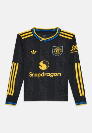 Black long-sleeve jersey with yellow and blue accents, featuring stripes on shoulders, Manchester United logo, and Snapdragon branding.