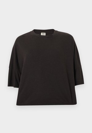 Czarny, oversize'owy t-shirt wykonany z bawełny, z okrągłym dekoltem i krótkimi rękawami, o gładkiej fakturze i luźnym kroju.