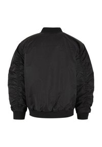 Blouson bomber noir avec manches froncées, poignets, col et taille côtelés, vu de dos sur fond blanc.