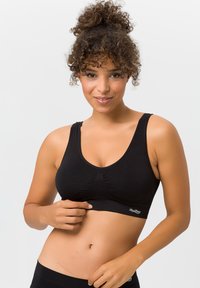 Schwarzer Sport-BH aus dehnbarem Stoff, mit breiten Trägern, einem runden Ausschnitt und einem gerafften Detail in der Mitte. Subtiles Logo am Saum.