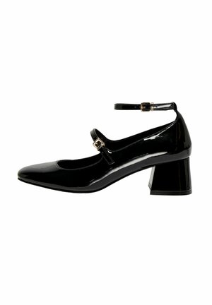 Chaussures Mary Jane en cuir verni noir avec un bout arrondi, une bride à la cheville ajustable et un talon block robuste. Texture lisse et brillante.