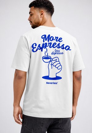 Man wearing white t-shirt with blue text "More Espresso less depresso" and graphic of hand holding steaming espresso cup on back.