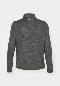 Long-sleeve, high-collar shirt in dark gray textured fabric. Features an embroidered logo at the neck and a streamlined design.