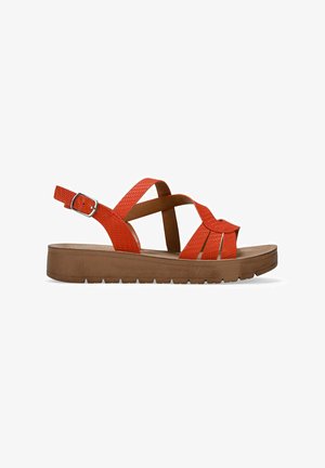 Orange sandal featuring textured straps, adjustable buckle, and a thick brown platform sole with a patterned tread.
