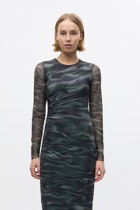Long-sleeve dress in dark green and gray with a wavy pattern, featuring a fitted bodice and sheer mesh sleeves. Smooth, stretchy fabric.
