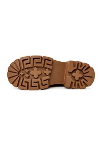 Bruine rubberen laarzensole met een textuurpatroon van geometrische vormen en uitsparingen, waaronder kruisen en Griekse sleutelmotieven.