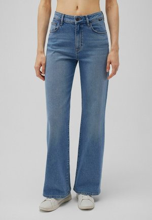 Light blue wide-leg jeans made of denim, featuring a high waist, five pockets, and contrast stitching. Worn with white sneakers.
