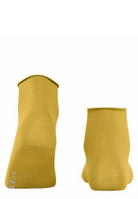Gelbe knöchelhohe Socken aus dehnbarem Material mit glatter Textur. Sie haben eine abgerundete Oberseite und Größenangaben an der Seite.