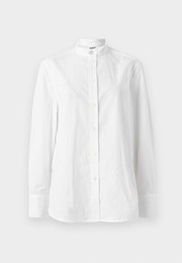 Λευκό πουκάμισο με μακριά μανίκια και κουμπιά, με γιακά μπροστινού τύπου, που διαθέτει λεία υφή και διακριτική πατιλέτα με κυκλικά κουμπιά.