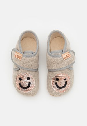 Gray fabric slippers with Velcro strap, featuring two smiley face appliqués in sequins on the front. Soft texture, rounded shape.