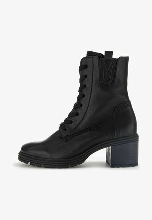 Black leather ankle boot with vertical lacing, a block heel, and textured rubber sole. Features subtle stitching detail on the sides.