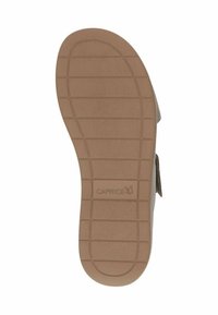 Braune Schuhsohle mit einem strukturierten Muster und horizontalen Rillen; zeigt den Markennamen "CAPRICE", der auf der Oberfläche geprägt ist.