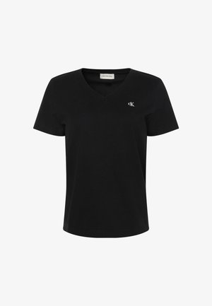 T-shirt en coton noir avec col en V, manches courtes et petit logo blanc "ck" sur le côté gauche de la poitrine. Texture lisse et coupe classique.