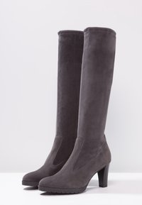Bottes montantes en daim gris avec un bout effilé, un talon bloc haut et des panneaux latéraux élastiques pour le confort. Texture lisse et design élégant.