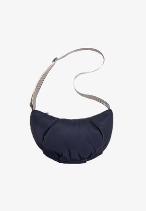 Navy blue crescent-shaped padded crossbody bag with black and white striped adjustable shoulder strap on a white background.