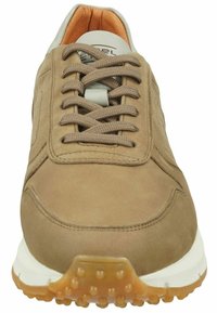 Brown suede sneaker with textured surface, rounded toe, and lace-up closure. White midsole and rubber outsole with dot pattern for grip.