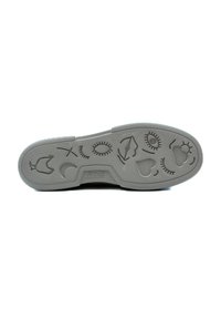 Suela de zapato de goma gris con patrones decorativos en relieve, que incluyen ojos, corazones y otras formas, con surcos texturizados para un mejor agarre.