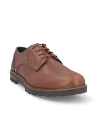 Zapato de vestir de piel marrón con un acabado suave, punta redondeada, suela de goma en contraste y detalle de costura elevada a lo largo de los costados.