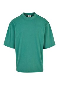 Tricou verde din bumbac, cu mâneci scurte, guler rotund, croială lejeră, textură netedă, fără modele sau logo-uri, cu tiv și cusături cusute.