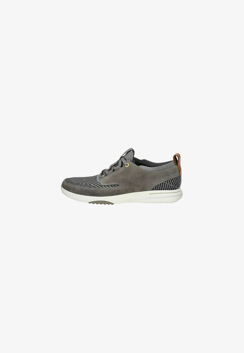 Gray casual shoe made of suede and mesh with a white sole. Features a lace-up design, rounded toe, and a decorative brown heel tab.