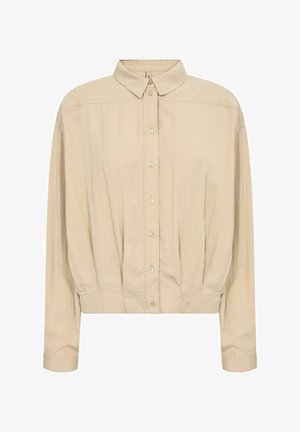 Vaalean beige pitkähihaisessa napitusesimessä on kauluskavu ja kerätty helma. Se on valmistettu sileästä, kevyestä kankaasta. Yksinkertainen malli, jossa on viisi nappia.