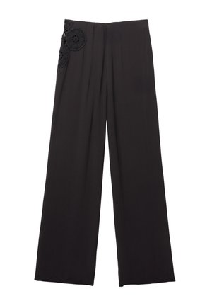 Black wide-leg pants with a smooth texture, featuring floral lace accents on the left side near the waistline.