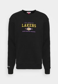 Sweat-shirt noir avec l'inscription "LOS ANGELES LAKERS" brodée en jaune et violet en caractères gras, col rond, manches longues et ourlet côtelé.