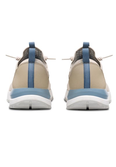 Beige athletic shoes with a blue accent stripe, textured upper, elastic laces, and white soles, viewed from the back with a pull tab.