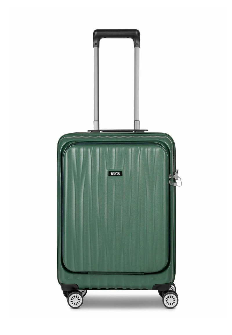 Valigia rigida verde con scanalature testurizzate, manico telescopico, quattro ruote bianche e patch con logo. Materiale resistente per l'uso durante i viaggi.