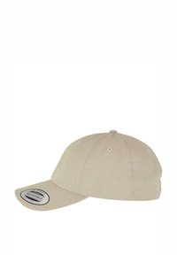 Adjustable beige cap with a curved brim, made from fabric. Features six ventilation holes and a circular patch on the front.